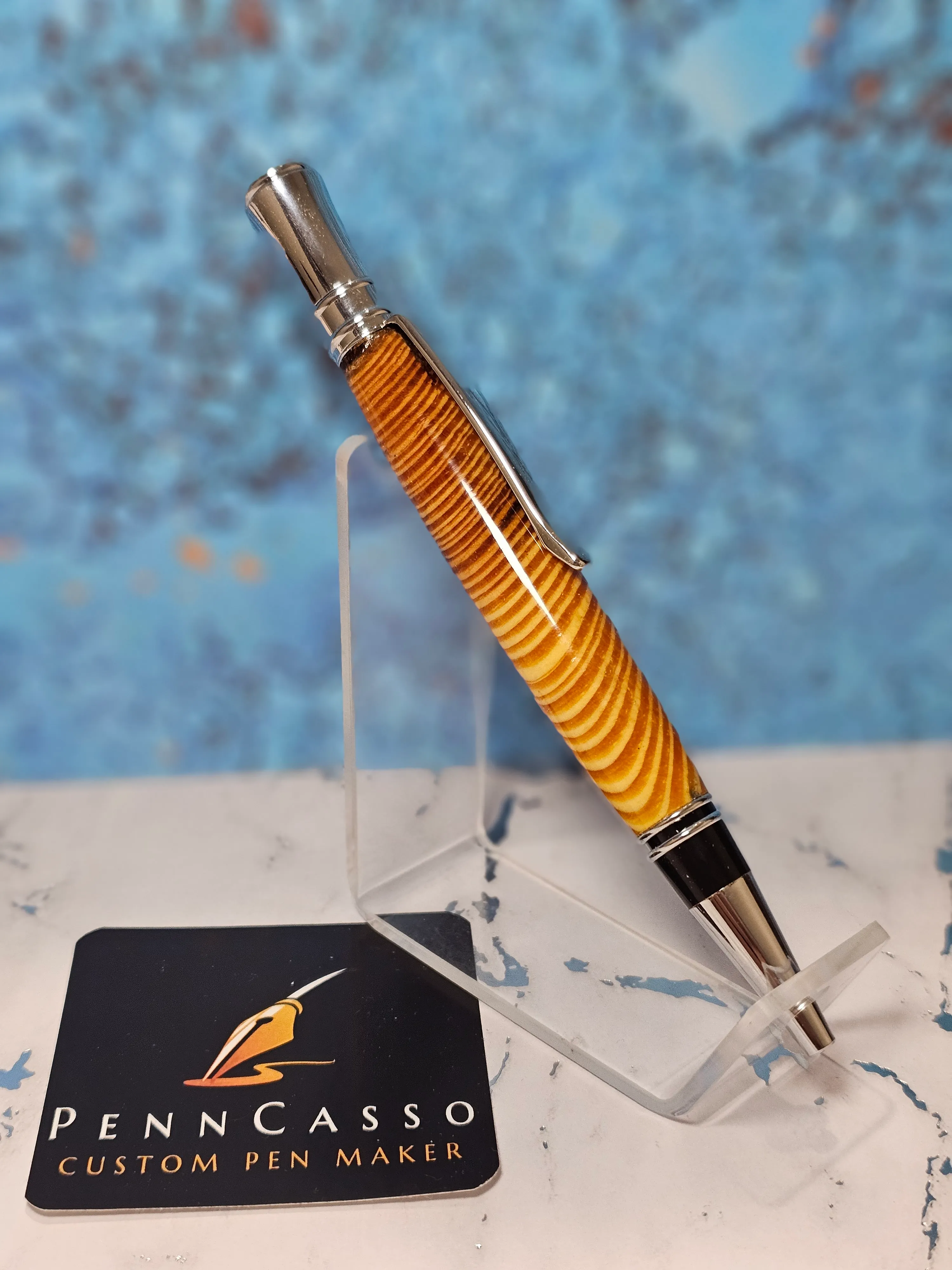 Amber-toned ribbed wooden pen with chrome accents