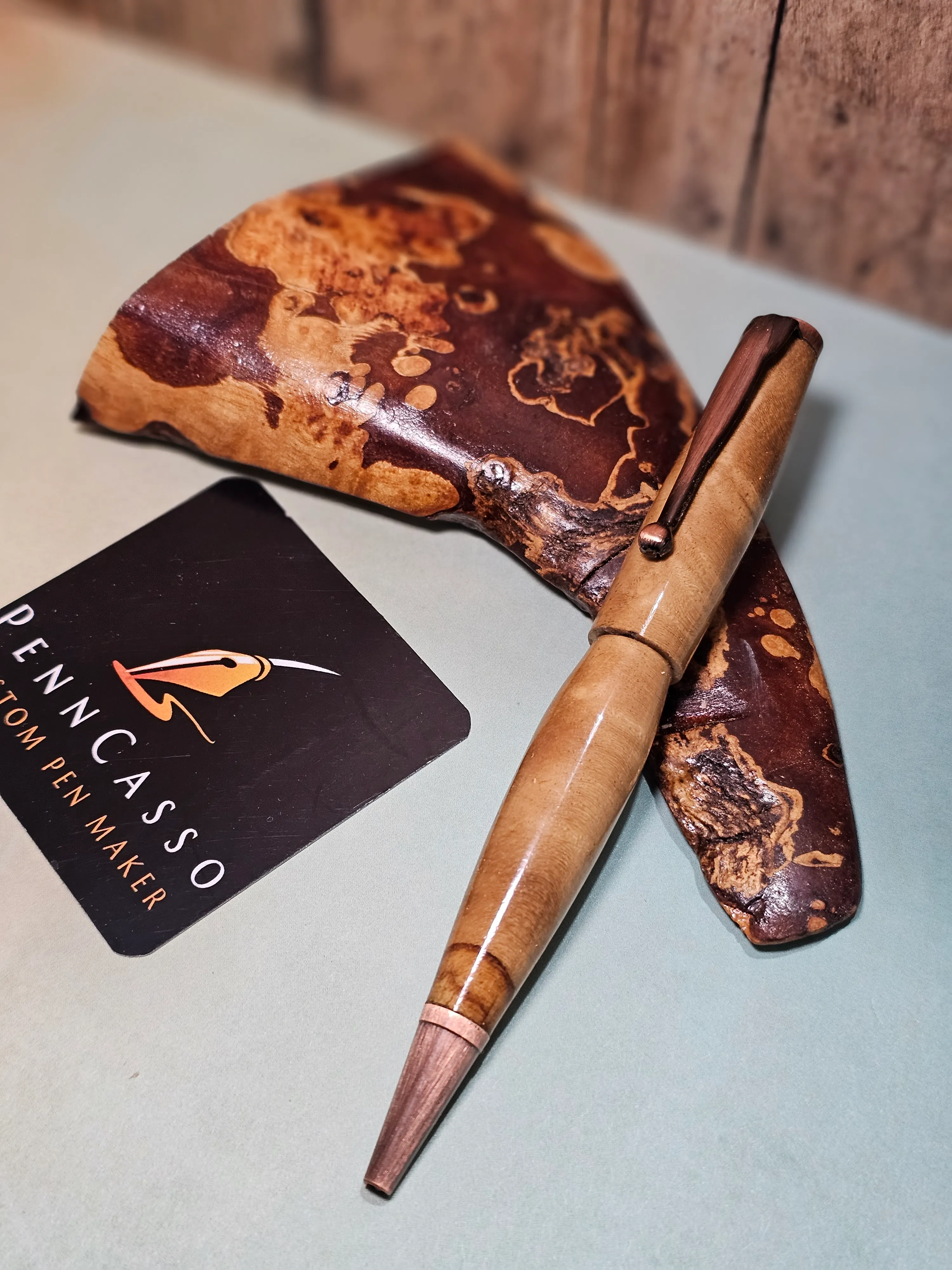 Twin custom pens on a burl-wood stand